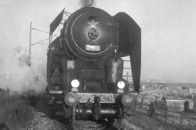  Parný rušeň 475.1120 na spojke Bratislava predmestie - Vinohrady odb. Pohľad zpredu. Vpravo vzadu spojka Vinohrady odb - Močiar odb. a záhradky. Foto: J. Kubáček, cca 1972. 110 x 110 