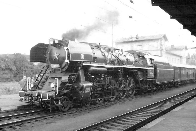  Parný rušeň 498.106 + Da + Fa (?) v žst. Praha-Vršovice. Pohľad zľava zpredu. Vpravo vzadu výpravná budova. Vpravo vpredu krytý perón. Anon., 27.9.1979. 174 x 121 