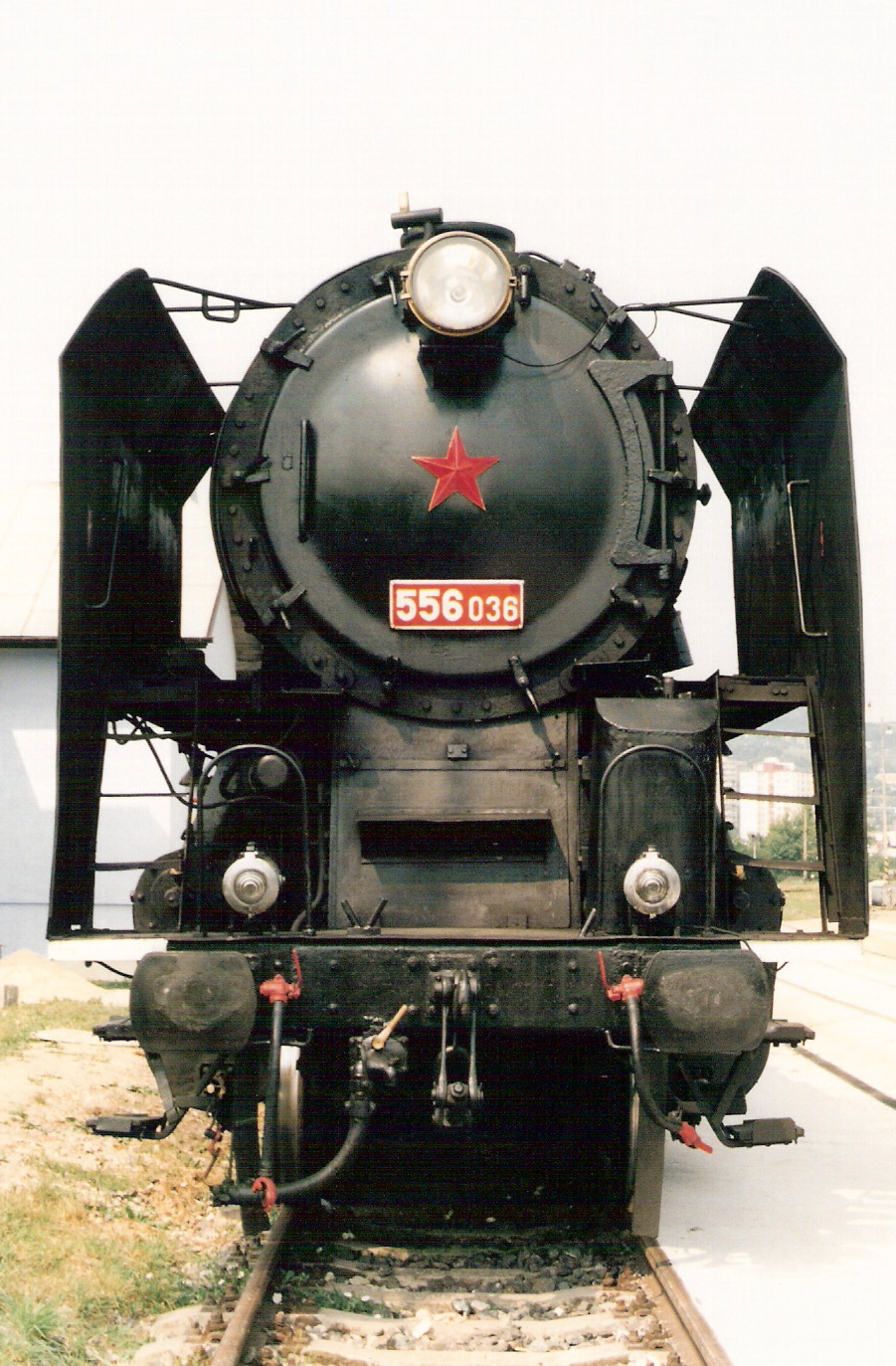  Parný rušeň 556.036 v obvode dezinfekč. stanice v starom depe Bratislava východ. Pohľad zpredu. Vľavo budova dezinfekč. stanice. Foto: M. Entner, 8.1998. 126 x 178, COLOR 