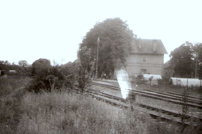  Šamorín - koľajisko a výpravná budova. Šikmý pohľad zo strany koľají od konca trate. Foto: J. Kubáček, cca 1982. 180 x 120 